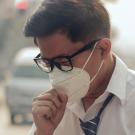 Hombre en calle con contaminación por el tráfico